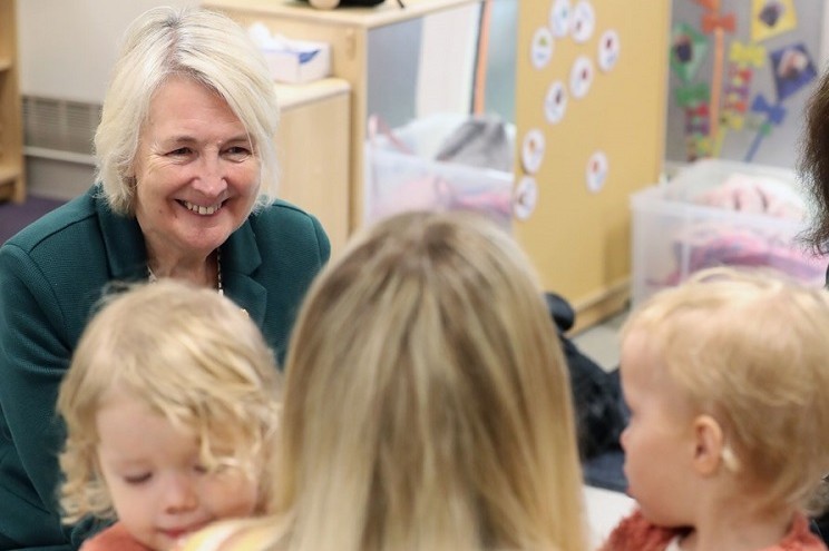 Siân Gwenllian engaging with young children in a classroom setting.