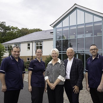 Sian Gwenllian standing with care home staff outside of building