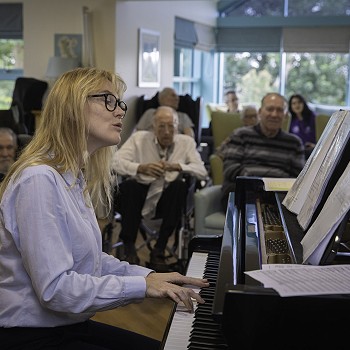 resident musician at Bryn Seiont Newydd playing the piano
