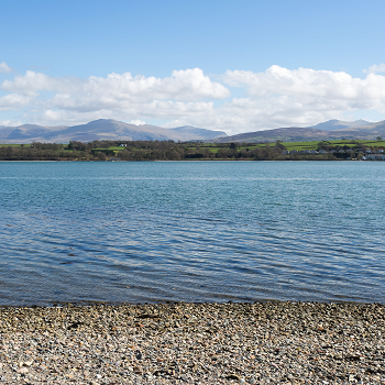 water with mountains in the background
